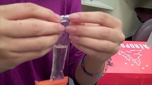 A person tying the visking tubing. Image credit YouTube.